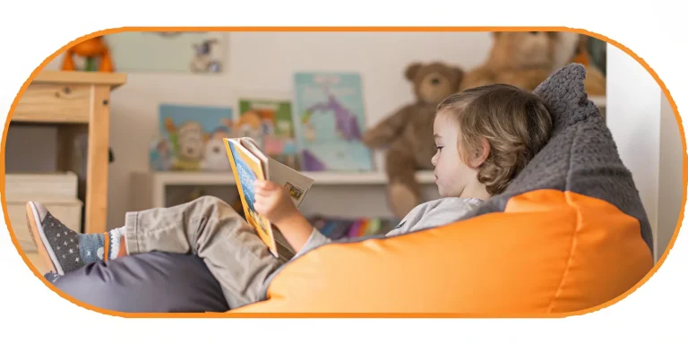 Second grader enjoys reading in cozy book nook.