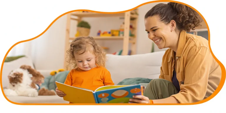 Kindergarten tutor assisting a young student with reading.