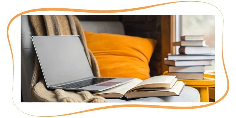 Reading tutor resources on a cozy couch with laptop and books.