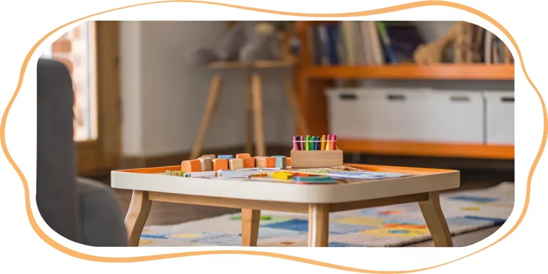 Kindergarten readiness tutor helps child with colorful blocks and crayons.