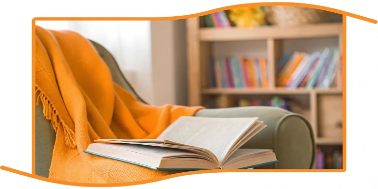 Child reading a book in cozy nook.